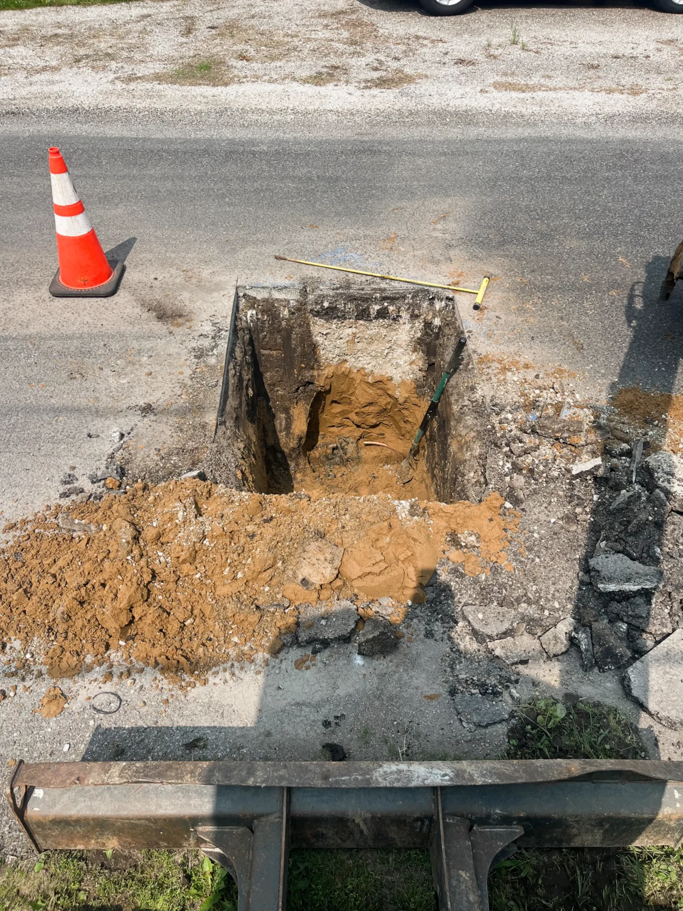 Double B Excavation Services excavating a sewer line in a roadway
