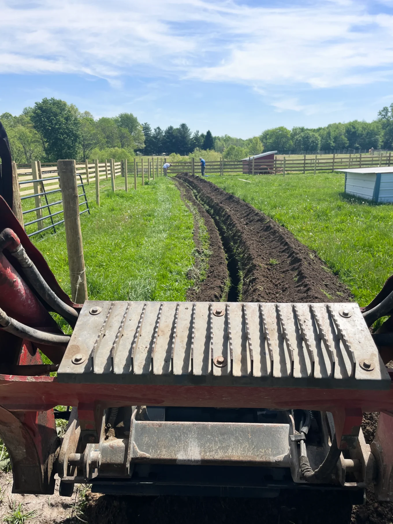 Double B Excavation Services installing a water line across a field