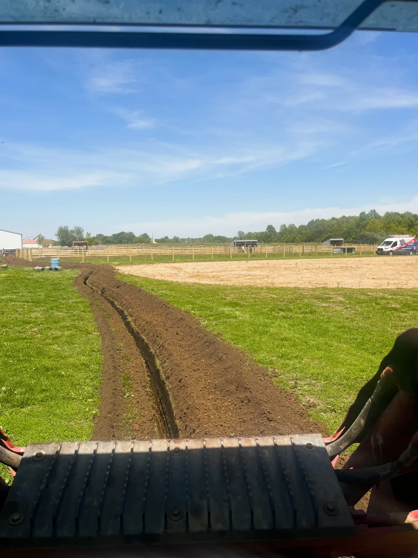Double B Excavation Services installing a water line across a field